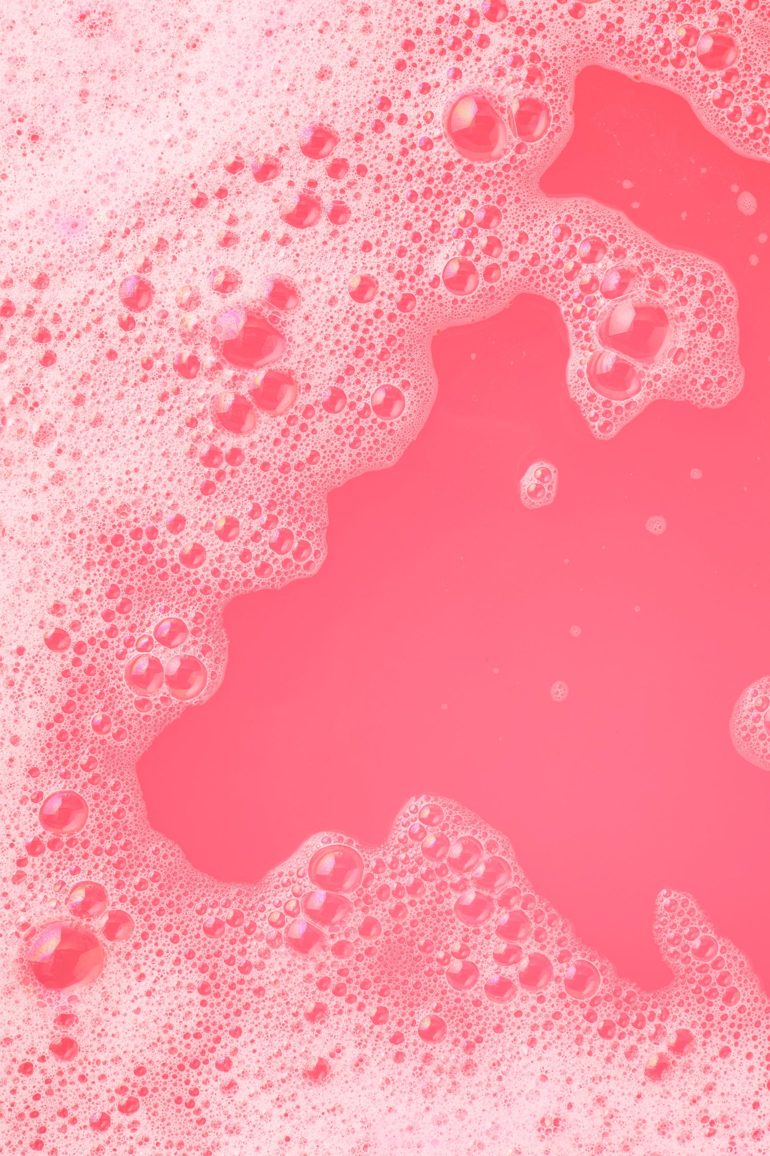 Pink liquid with bubbles on a pink background
