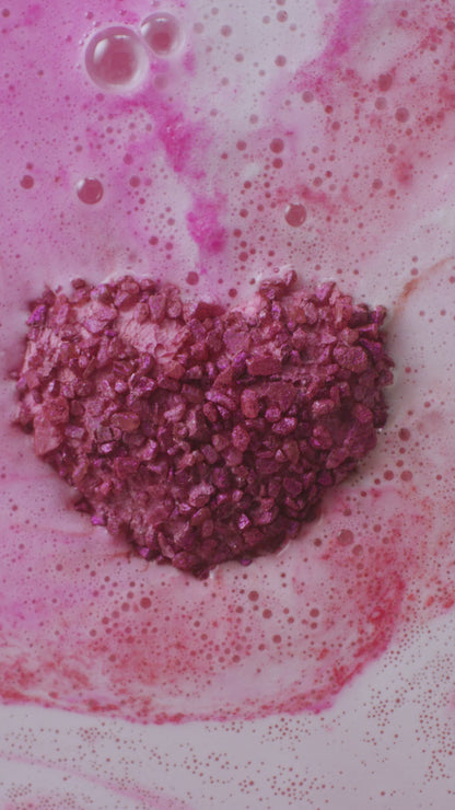 Pink bath bomb in a bath