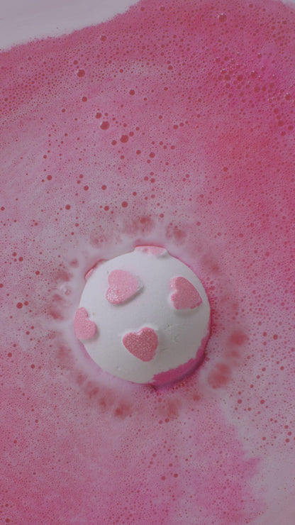Pink bath bomb in a bath
